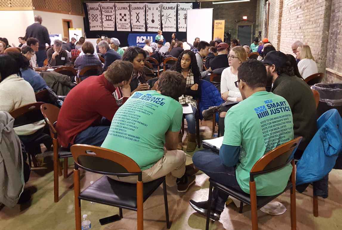 People sitting in a group around a table.